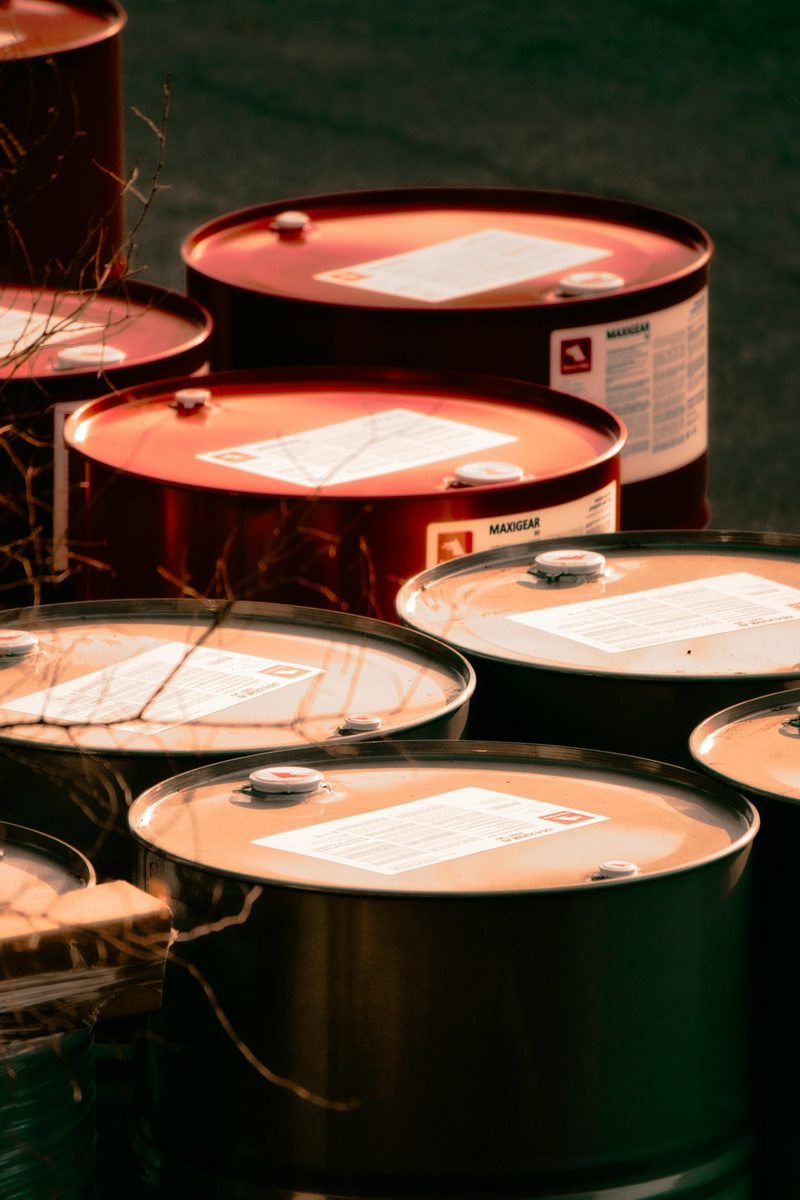 Industrial drums and barrels stacked on pallets in a warehouse
